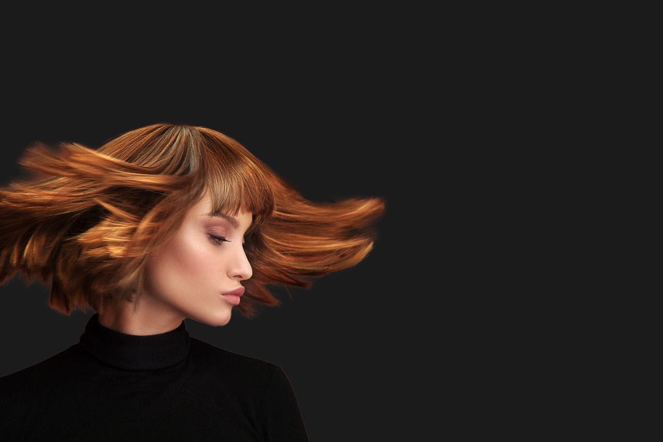 Woman with short hair and a blonde hue, captured in mid-motion with her head turned to the side, conveying a sense of movement against a dark background.